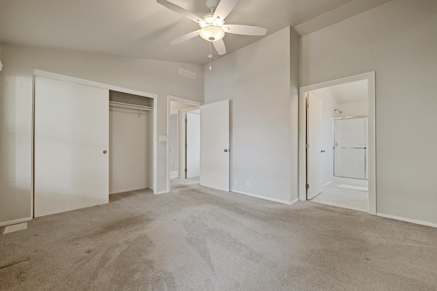 2621 Prescott, Unit 92 Modesto, CA 95350 - Photo 22 of 25 an empty room with closet and a ceiling fan