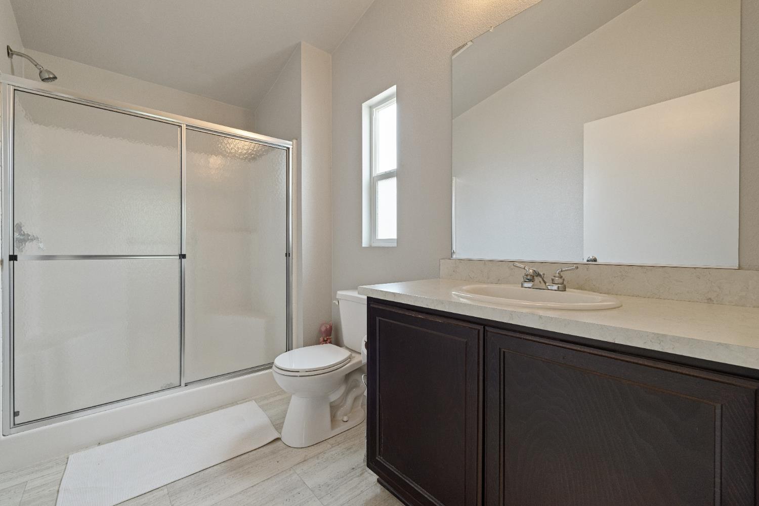 2621 Prescott, Unit 92 Modesto, CA 95350 - Photo 23 of 25 a bathroom with a sink toilet and shower