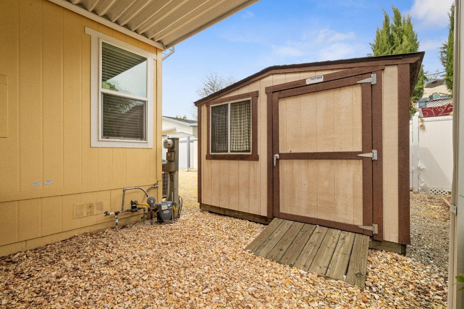 2621 Prescott, Unit 92 Modesto, CA 95350 - Photo 24 of 25 a front view of a house with a yard