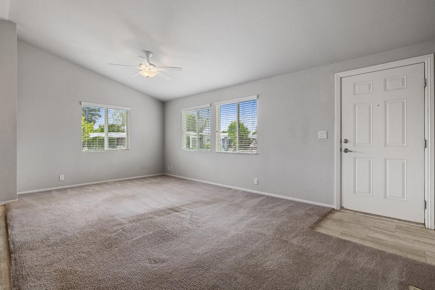 2621 Prescott, Unit 92 Modesto, CA 95350 - Photo 6 of 25 an empty room with windows and ceiling fan