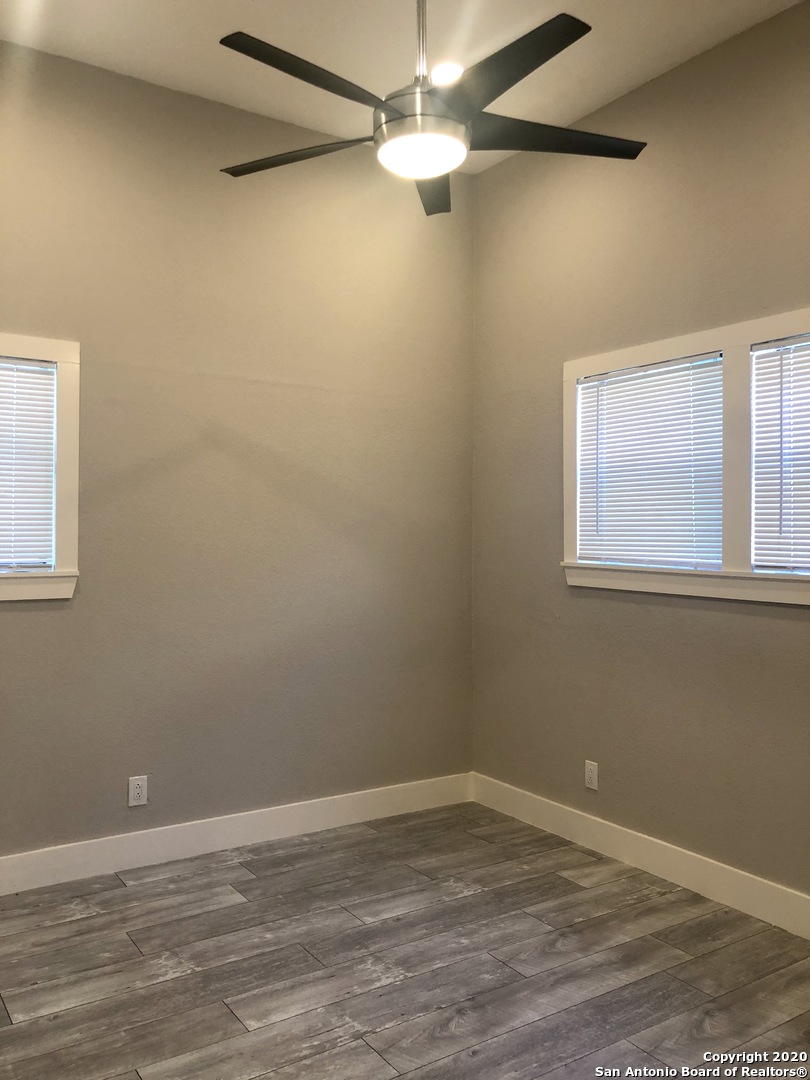 603 Devine Street, Unit 2 San Antonio, TX 78210 - Photo 13 of 16 a view of a room with wooden floor and a ceiling fan