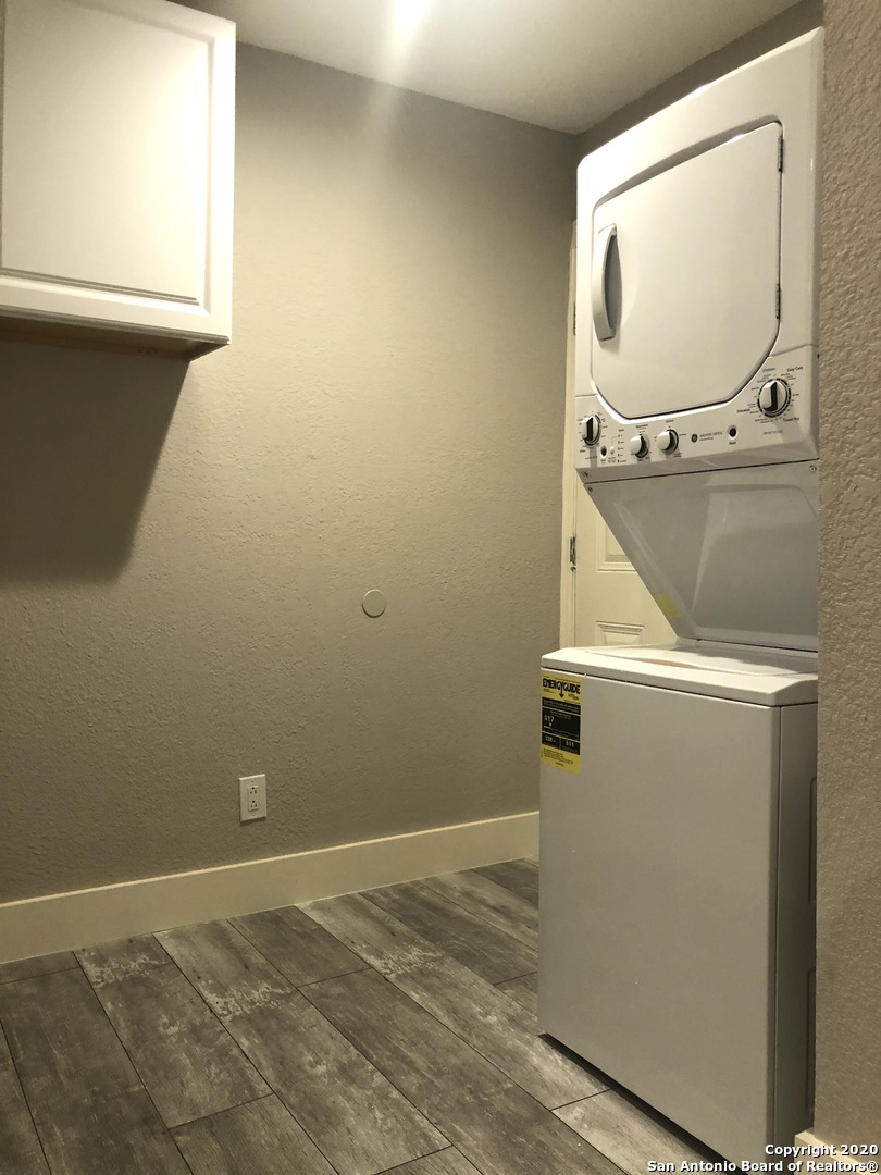 603 Devine Street, Unit 2 San Antonio, TX 78210 - Photo 15 of 16 a view of a room with wooden floor and mirror