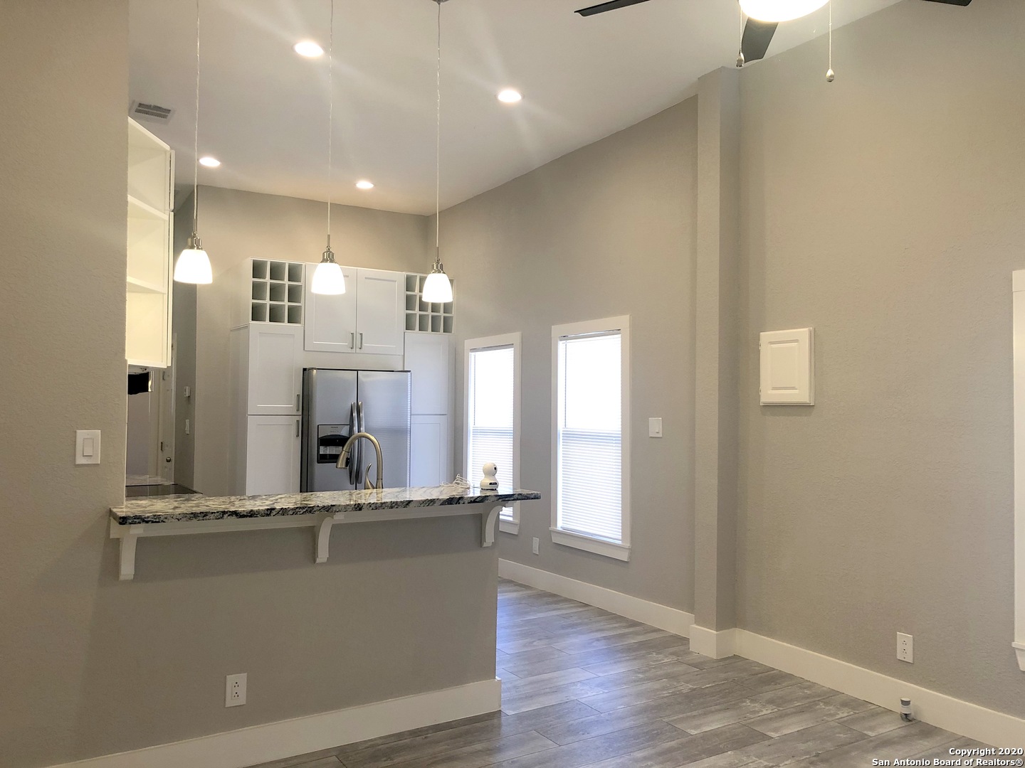 603 Devine Street, Unit 2 San Antonio, TX 78210 - Photo 5 of 16 a view of a living room with kitchen island stainless steel appliances wooden floor and window