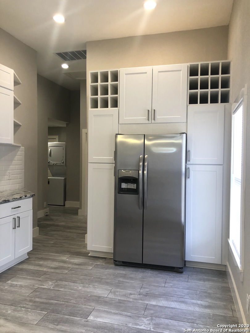 603 Devine Street, Unit 2 San Antonio, TX 78210 - Photo 9 of 16 a kitchen with granite countertop a refrigerator and a sink