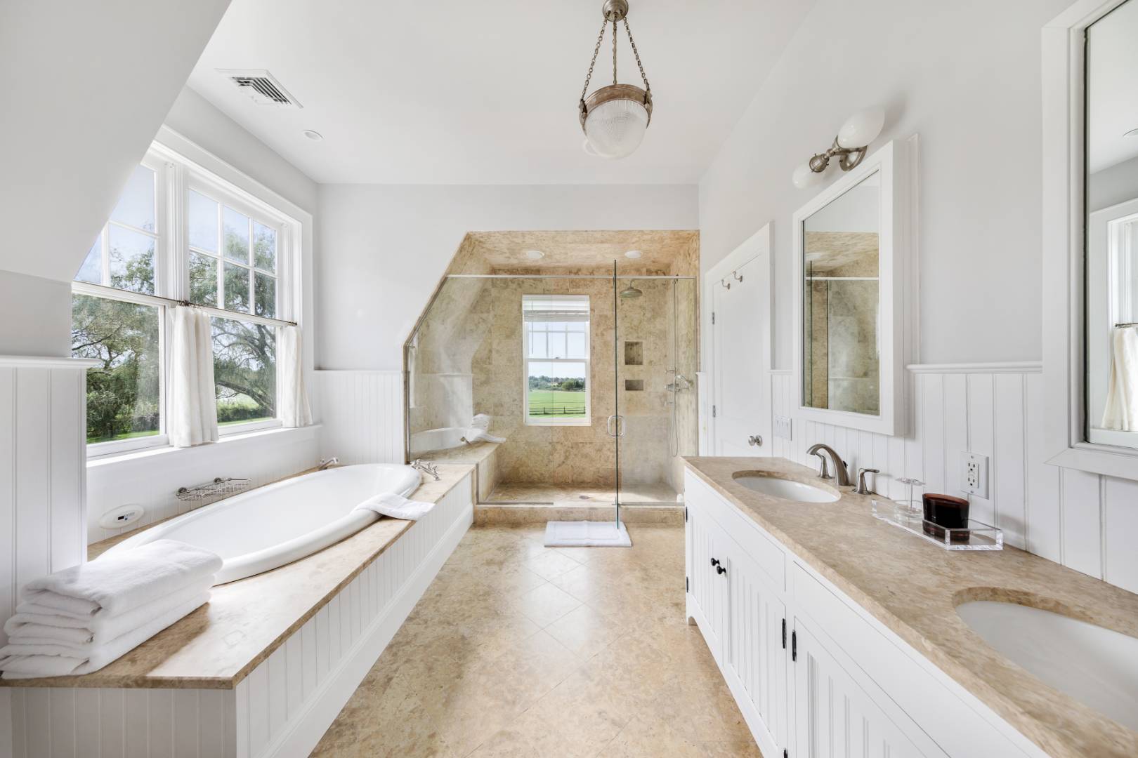 10 Dannielles Way Bridgehampton, NY 11976 - Photo 13 of 27 a spacious en suite bathroom with a granite countertop tub and a large window