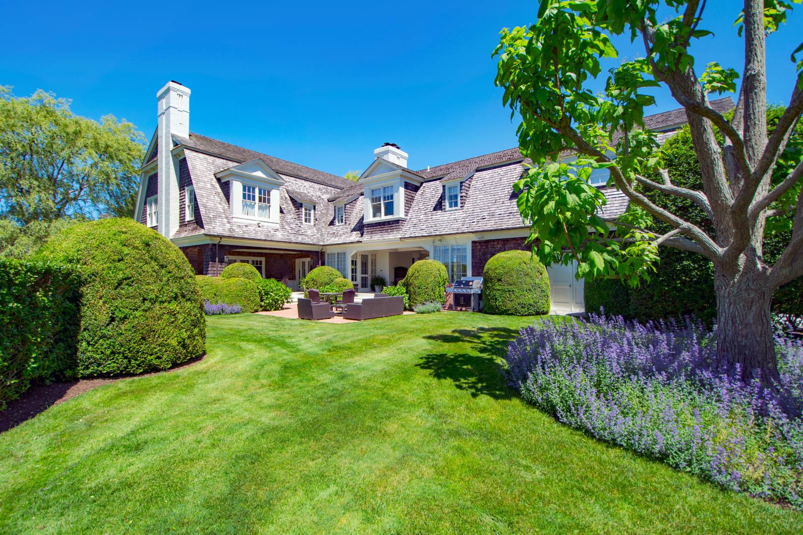 10 Dannielles Way Bridgehampton, NY 11976 - Photo 25 of 27 a view of a house with a big yard and large trees