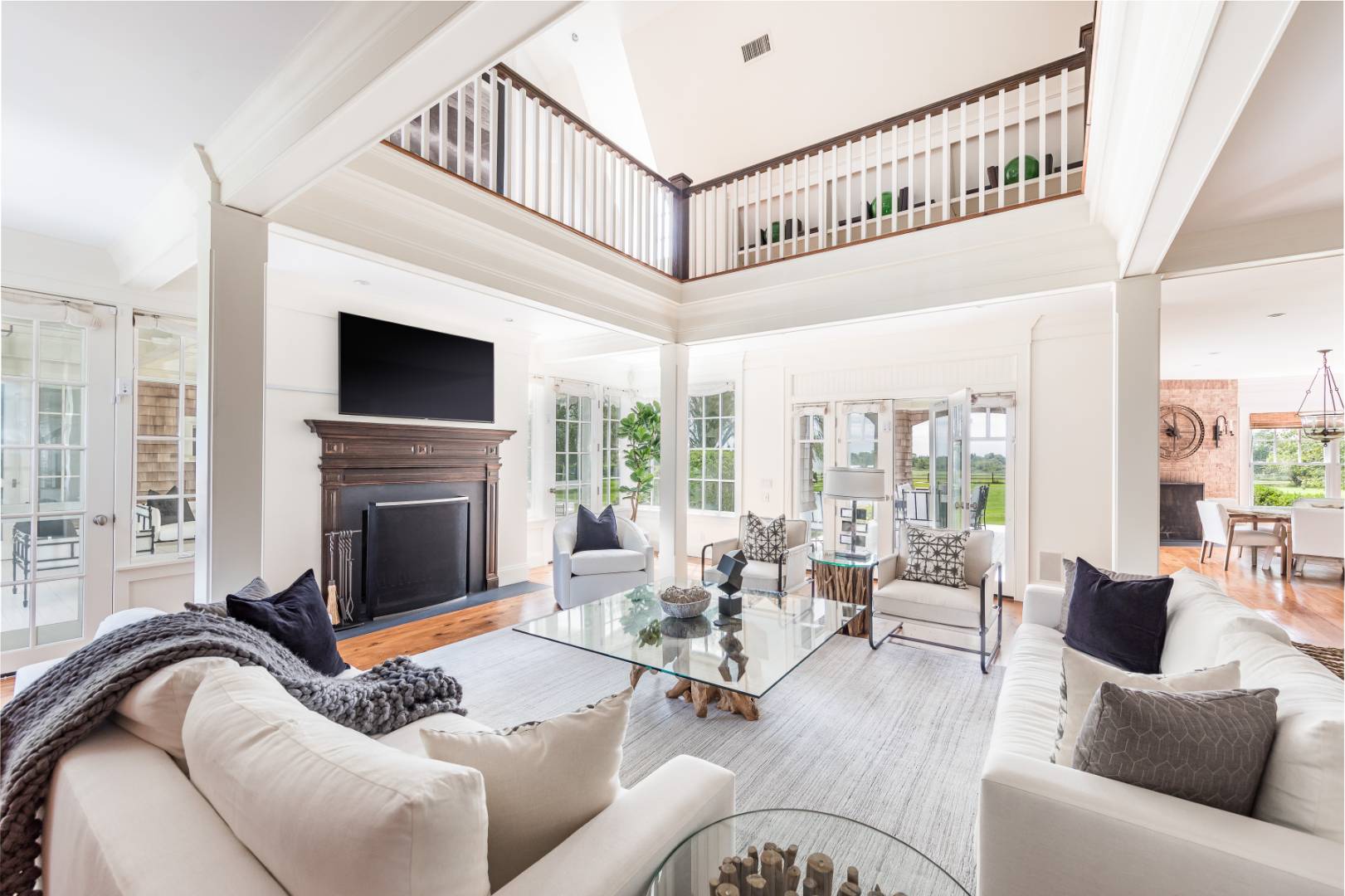 10 Dannielles Way Bridgehampton, NY 11976 - Photo 8 of 27 a living room with furniture a fireplace and a flat screen tv