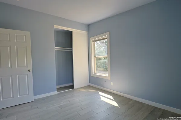 a bathroom with a toilet a sink and a window