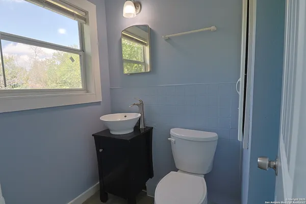 a bathroom with a glass shower door