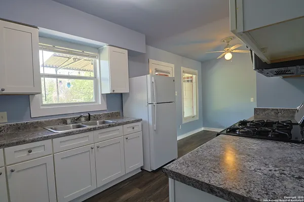 a kitchen with a sink stove and refrigerator