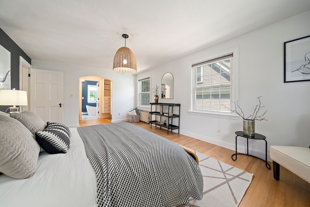 23 Regina Road Newton, MA 02466 - Photo 19 of 42 a bedroom with a bed a chandelier and windows