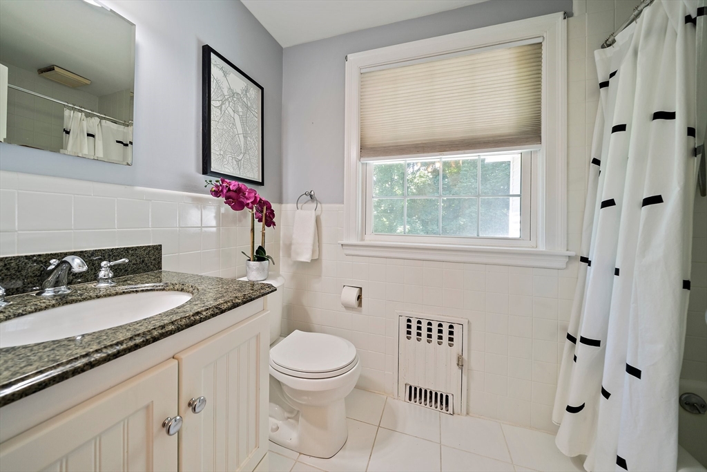 23 Regina Road Newton, MA 02466 - Photo 26 of 42 a bathroom with a granite countertop sink toilet and shower