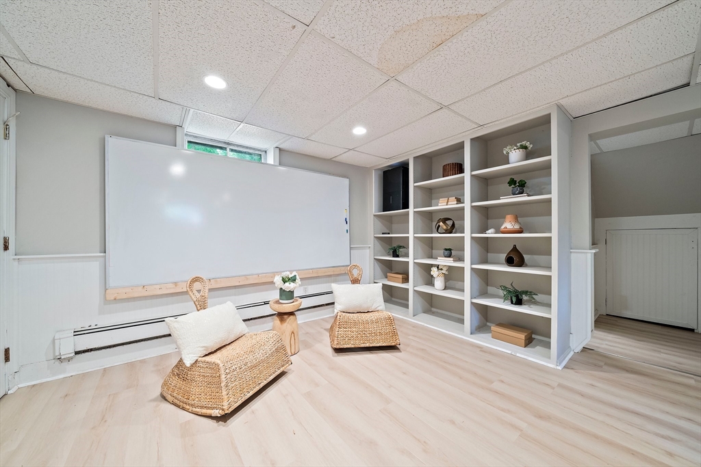 23 Regina Road Newton, MA 02466 - Photo 29 of 42 a living room with furniture and a book shelf