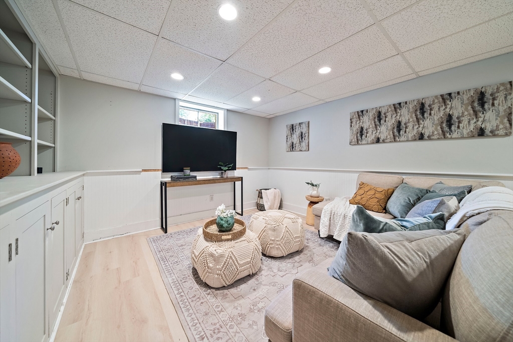 23 Regina Road Newton, MA 02466 - Photo 30 of 42 a living room with furniture and a flat screen tv