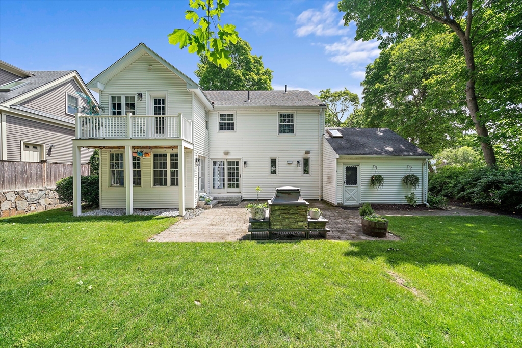 23 Regina Road Newton, MA 02466 - Photo 34 of 42 a front view of a house with a garden and yard