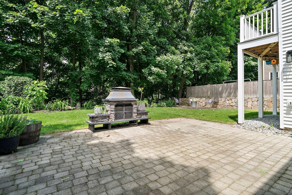 23 Regina Road Newton, MA 02466 - Photo 36 of 42 a white house with a small yard and large trees