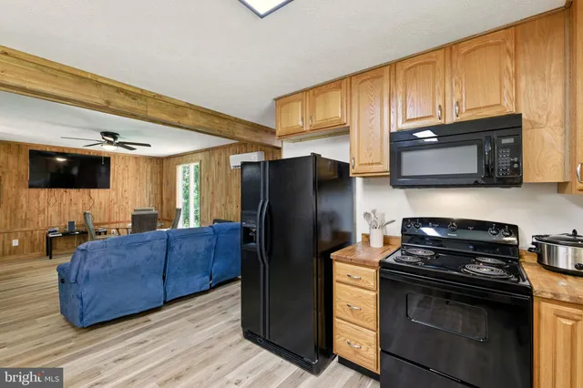 a kitchen with stainless steel appliances granite countertop a stove and a microwave
