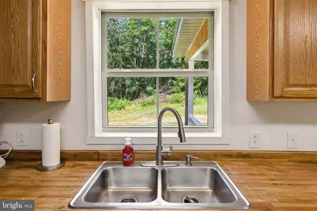 a kitchen with granite countertop a stove and a microwave