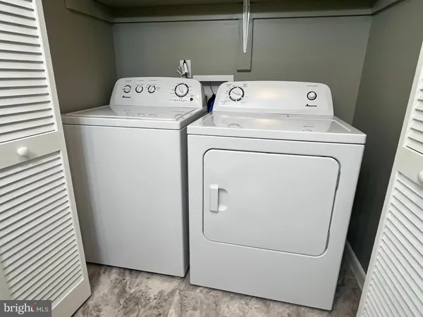 a bedroom with a large bed and a large window