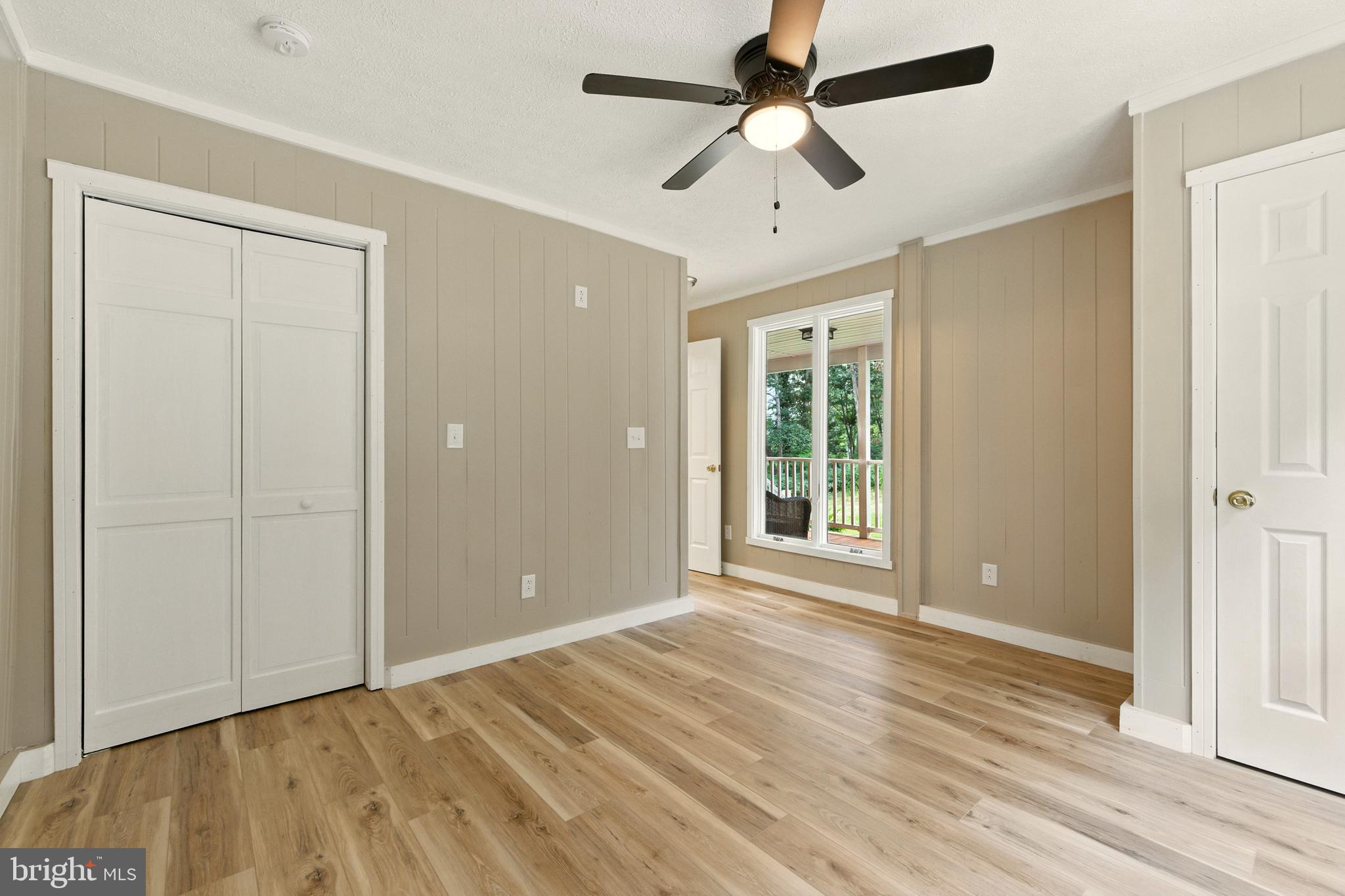 114 Americana Road Luray, VA 22835 - Photo 30 of 67 an empty room with wooden floor chandelier fan and windows