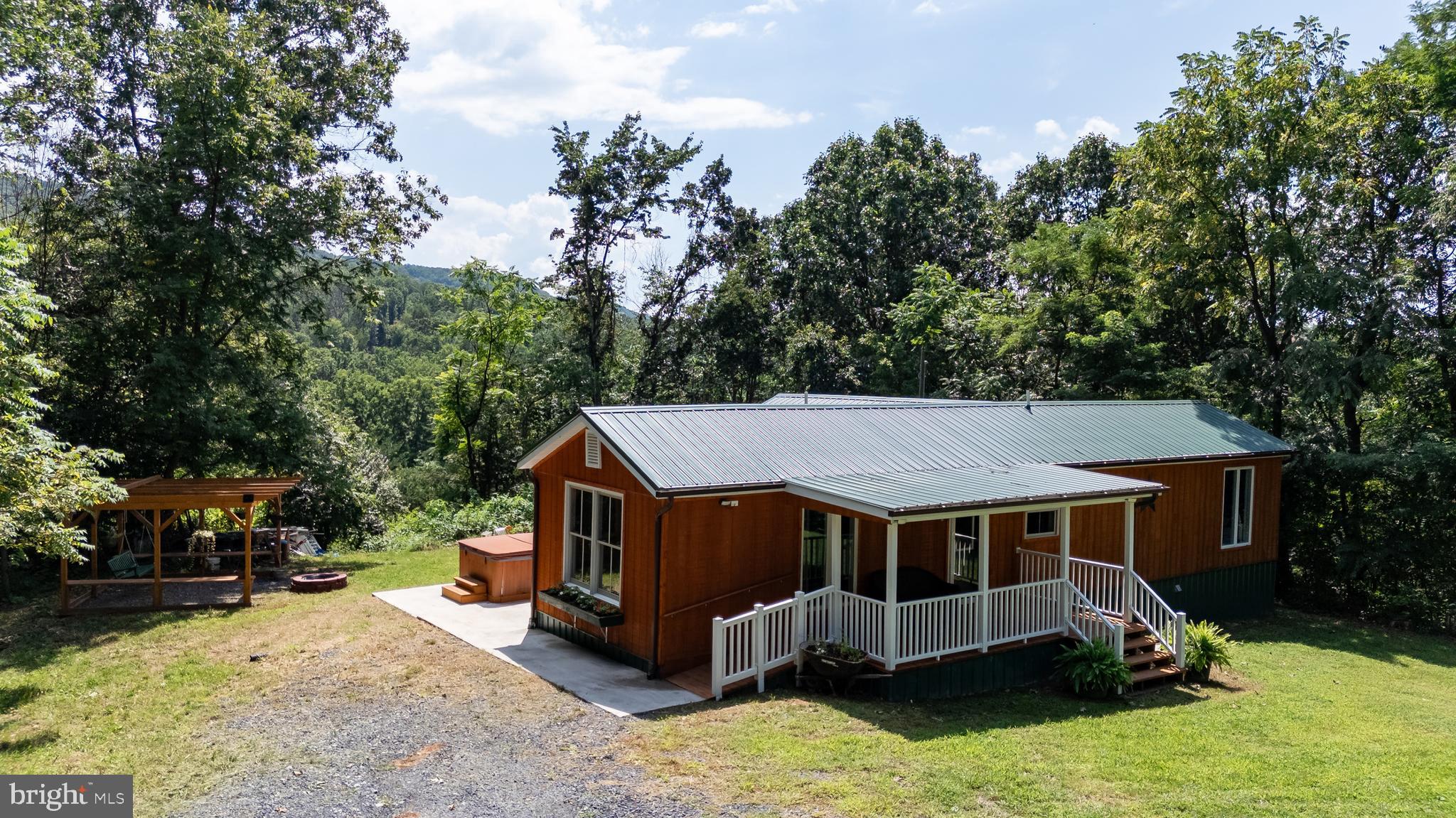 114 Americana Road Luray, VA 22835 - Photo 3 of 67 an aerial view of a house with yard and trees in the background