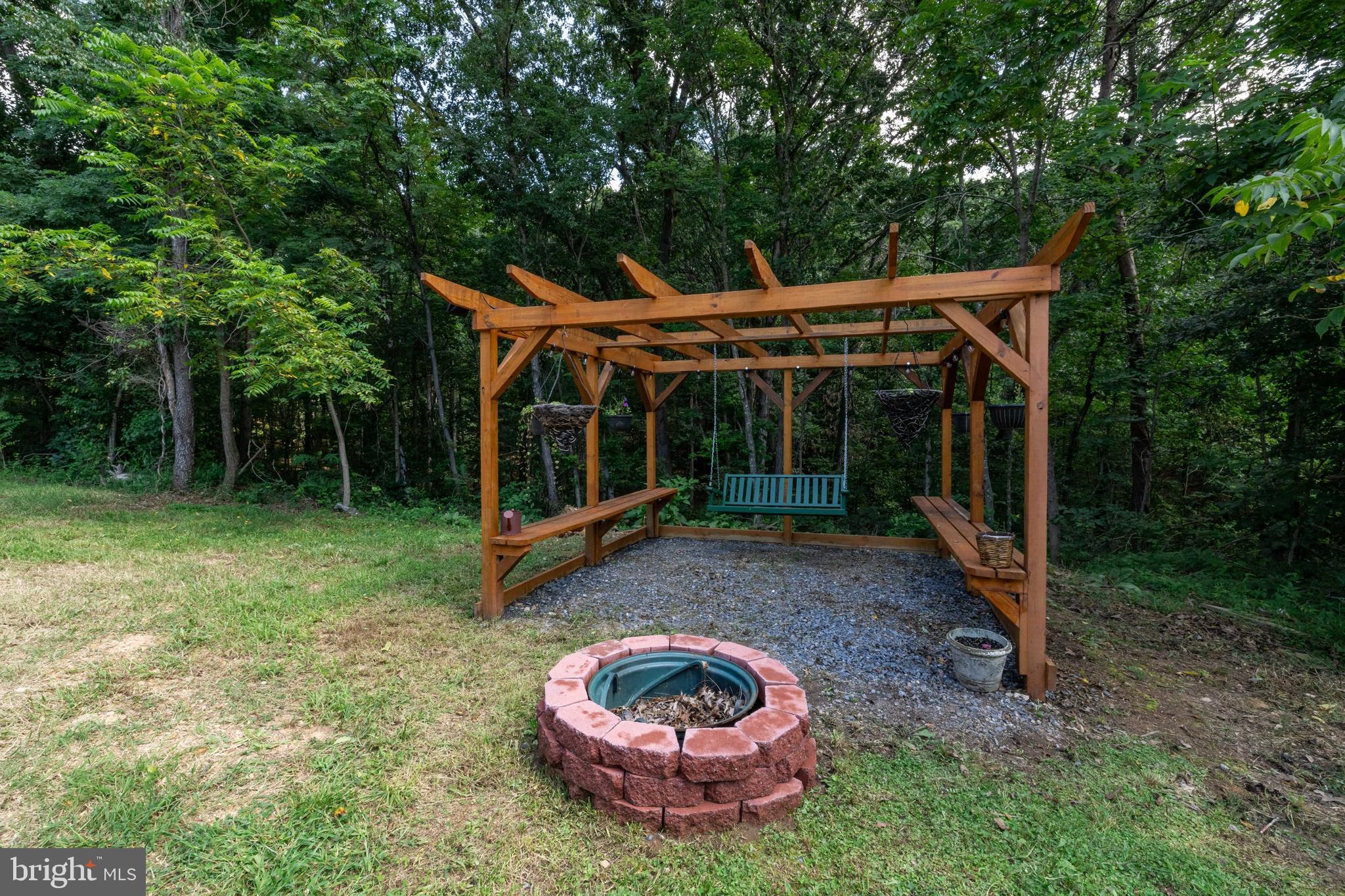 114 Americana Road Luray, VA 22835 - Photo 49 of 67 a backyard of a house with garden and outdoor seating
