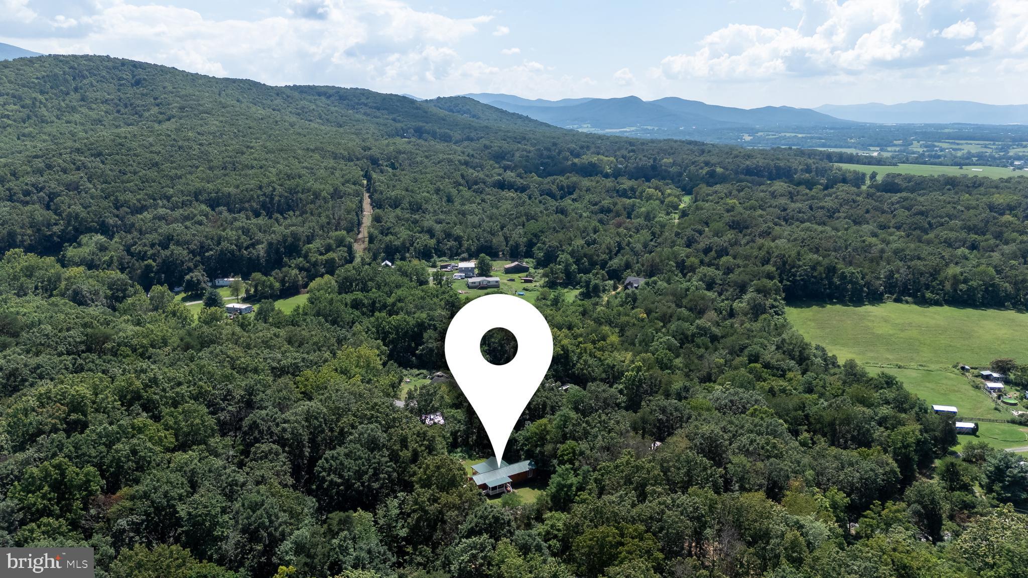 114 Americana Road Luray, VA 22835 - Photo 64 of 67 a view of a house with a mountain and a forest