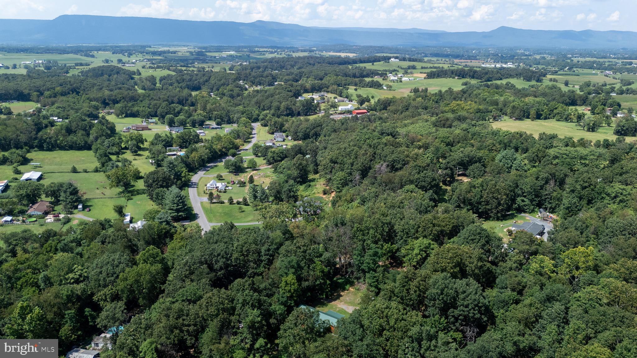 114 Americana Road Luray, VA 22835 - Photo 67 of 67 an aerial view of a city with lots of residential buildings and mountain view in back