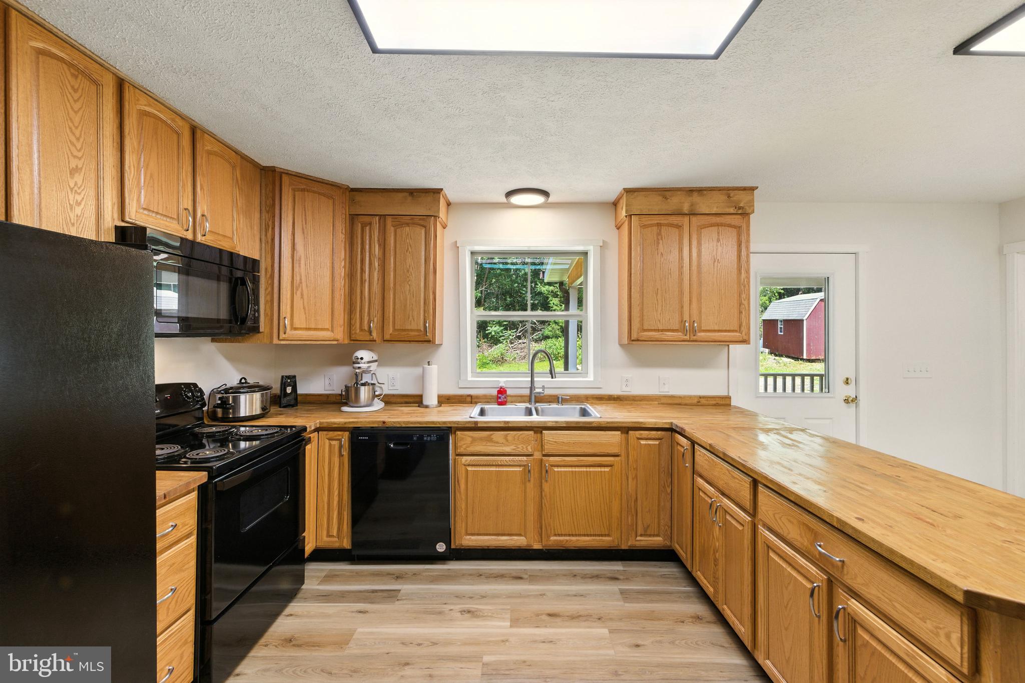 114 Americana Road Luray, VA 22835 - Photo 9 of 67 a kitchen with a sink stove top oven and cabinets
