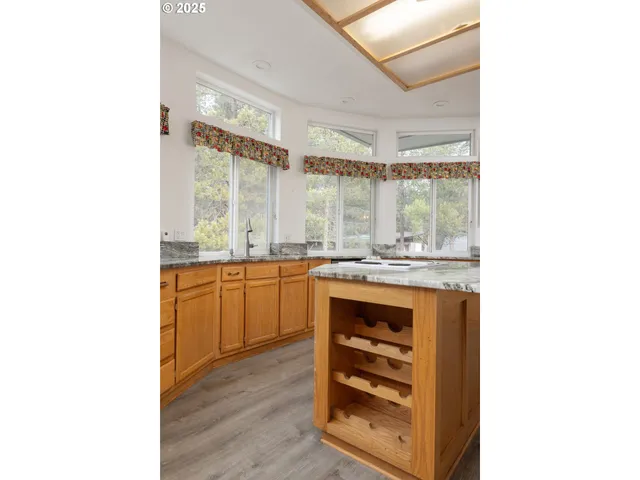 a kitchen with a sink cabinets and a window