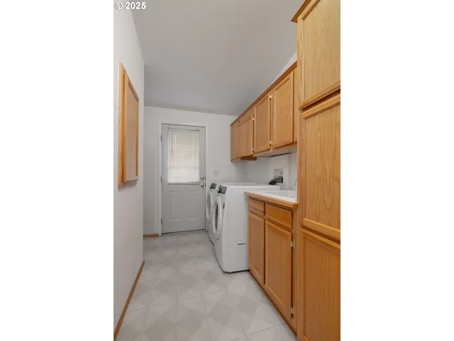 a view of a kitchen with white cabinets