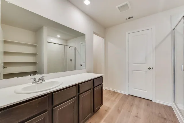 a bathroom with a sink double vanity and a mirror
