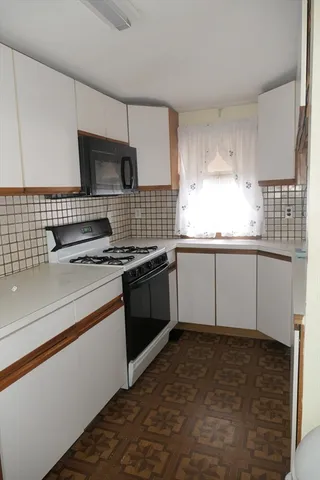 a kitchen with granite countertop a sink and a stove top oven