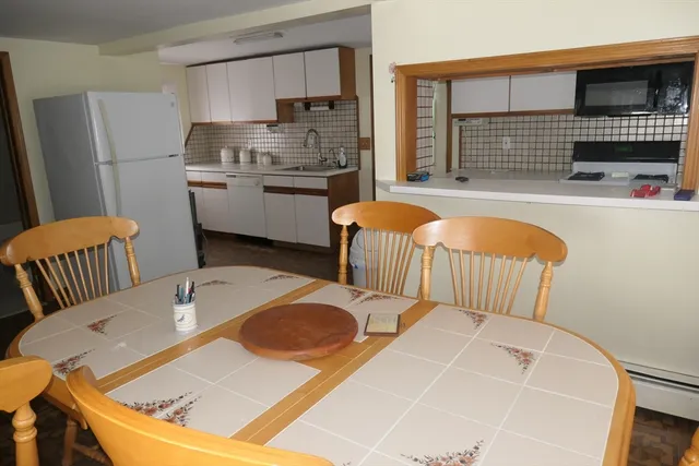 a bathroom with a granite countertop toilet and a sink