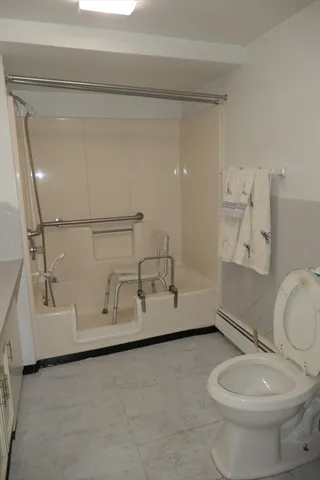 a bathroom with a sink a toilet a mirror and vanity