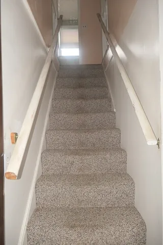 a white toilet sitting next to a bathroom sink and a window