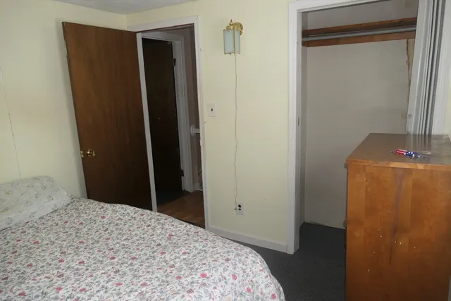 a bed sitting in a bedroom next to a window