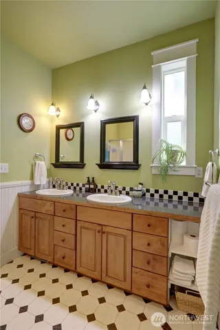 a bathroom with a sink a vanity and a mirror