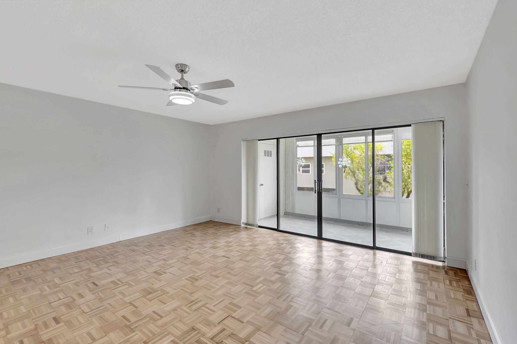 124 Capri B Delray Beach, FL 33484 - Photo 11 of 69 wooden floor in an empty room with a window