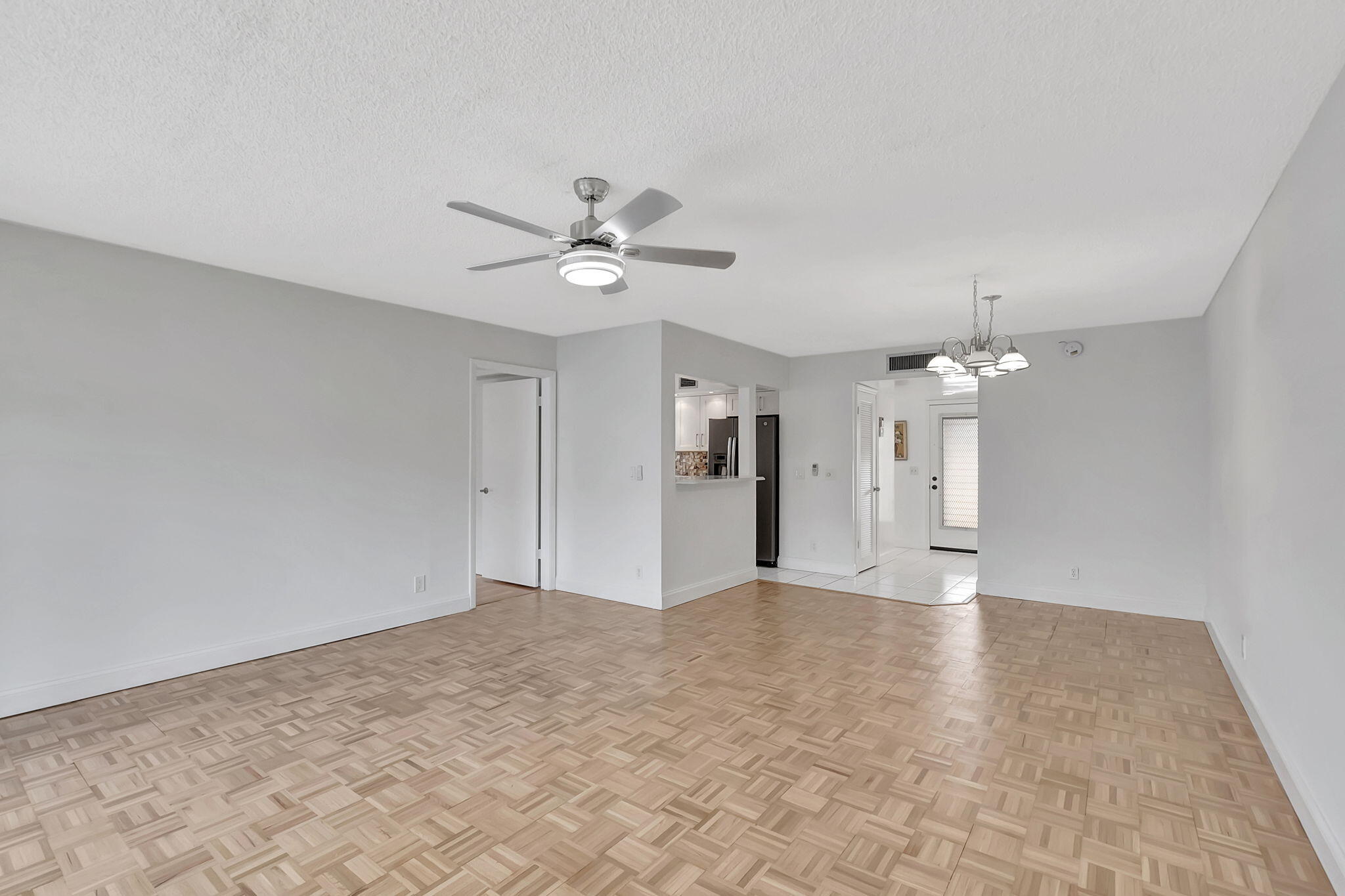 124 Capri B Delray Beach, FL 33484 - Photo 14 of 69 a view of an empty room with a chandelier fan