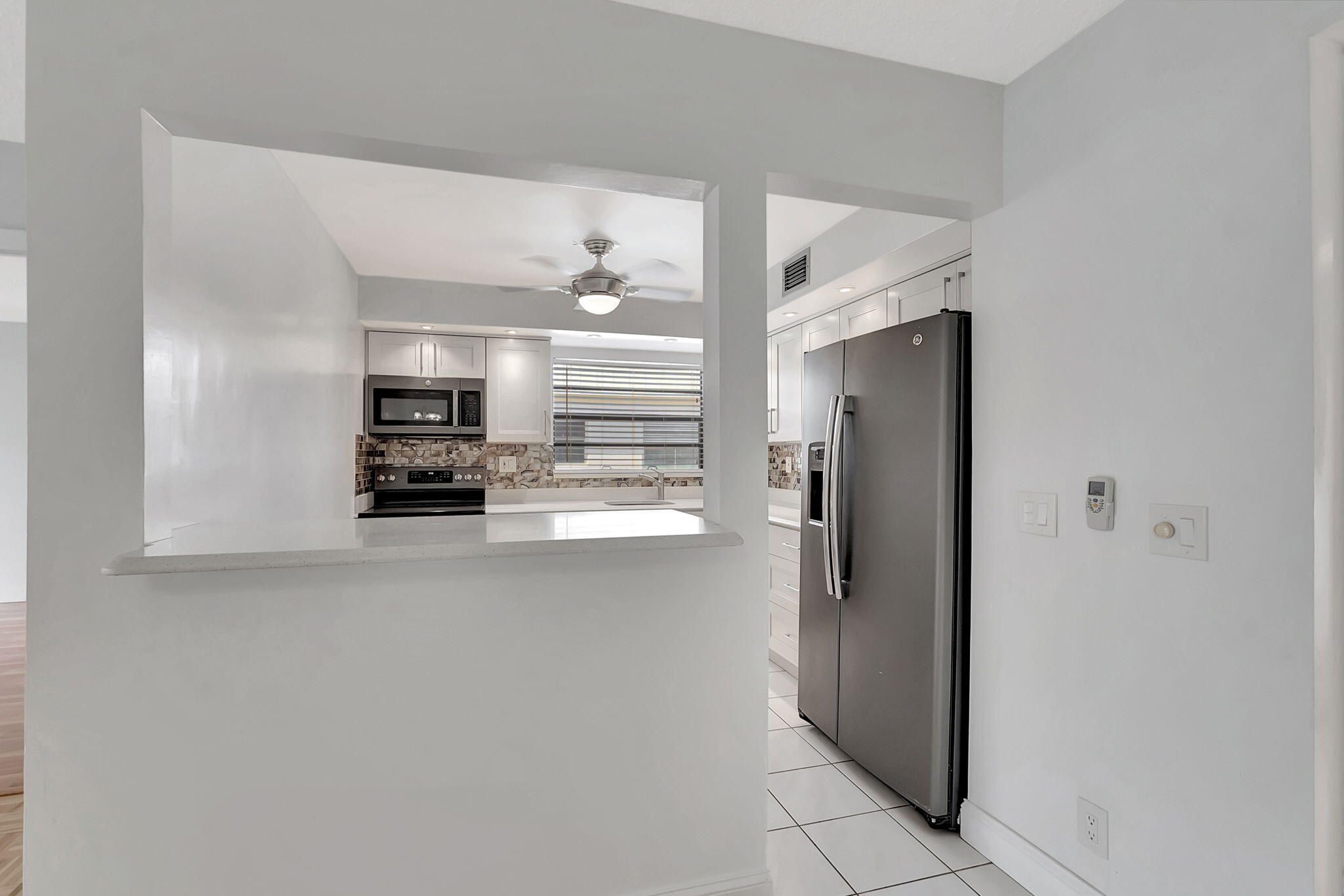 124 Capri B Delray Beach, FL 33484 - Photo 15 of 69 a kitchen with stainless steel appliances a refrigerator and microwave