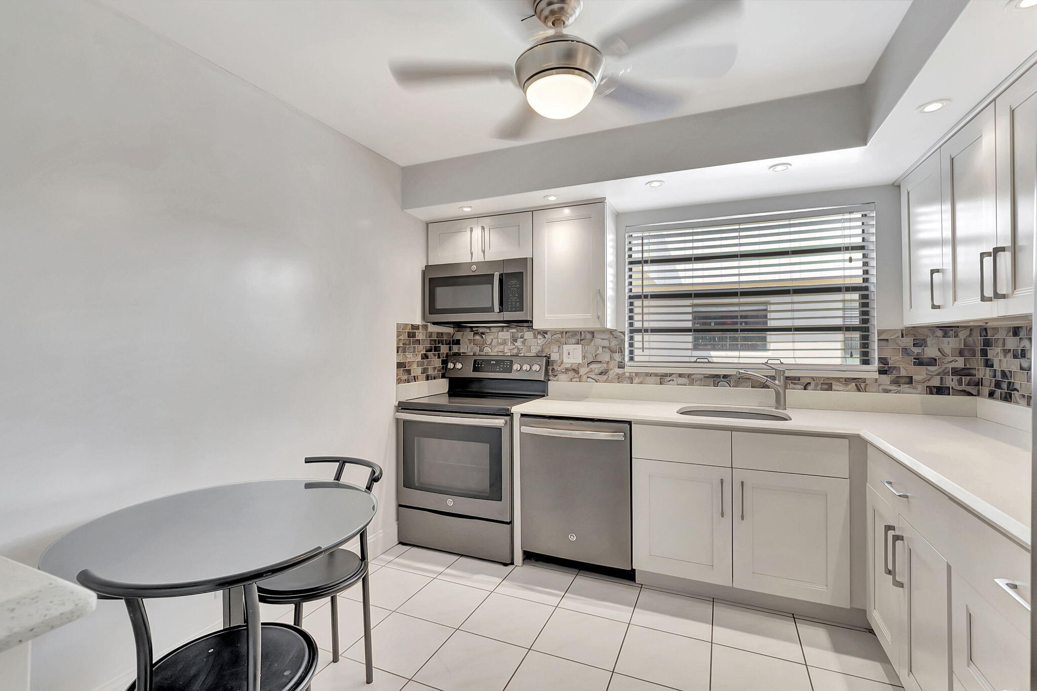 124 Capri B Delray Beach, FL 33484 - Photo 16 of 69 a kitchen with cabinets appliances and a sink