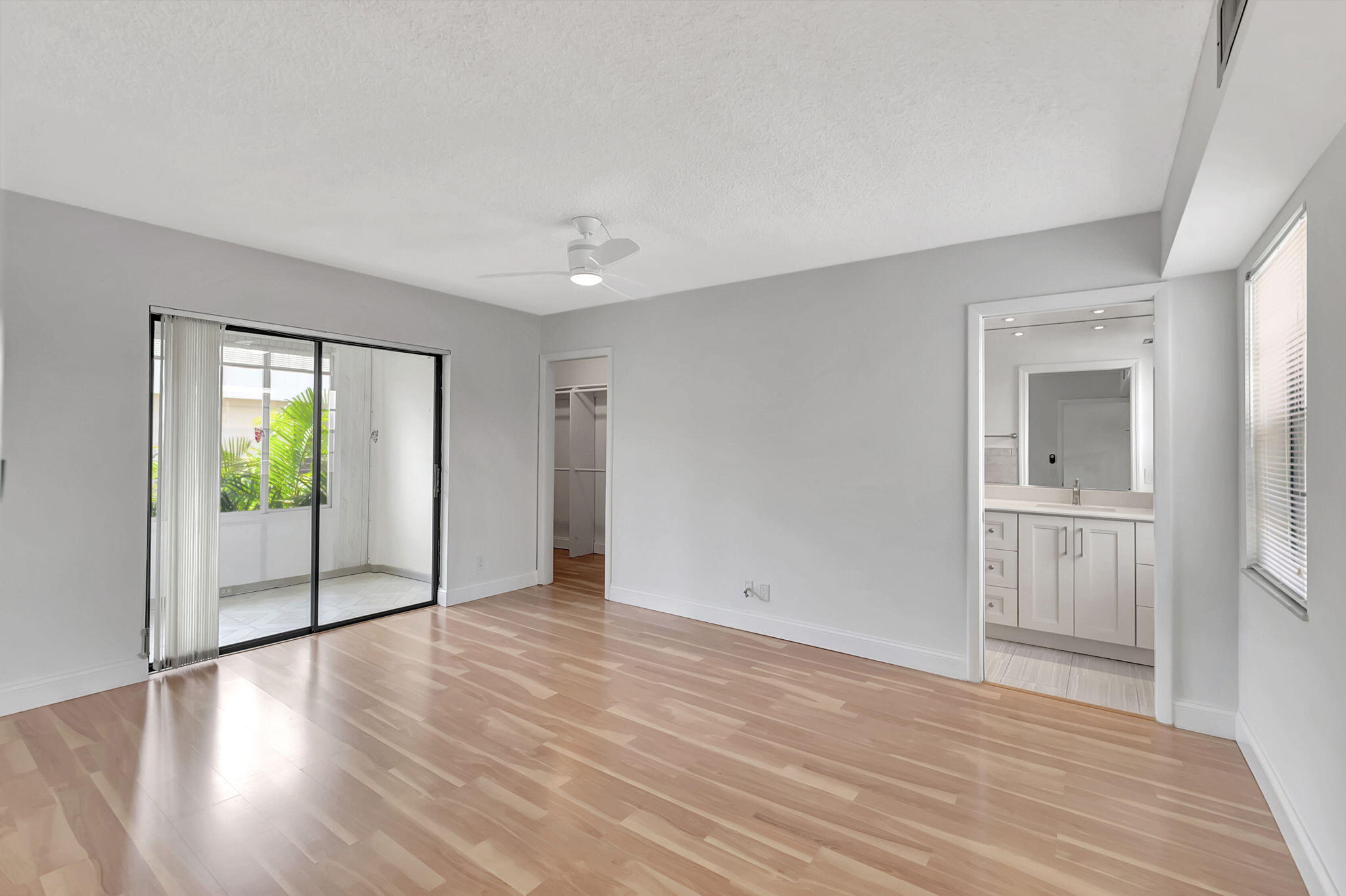 124 Capri B Delray Beach, FL 33484 - Photo 19 of 69 a view of empty room with wooden floor and fan