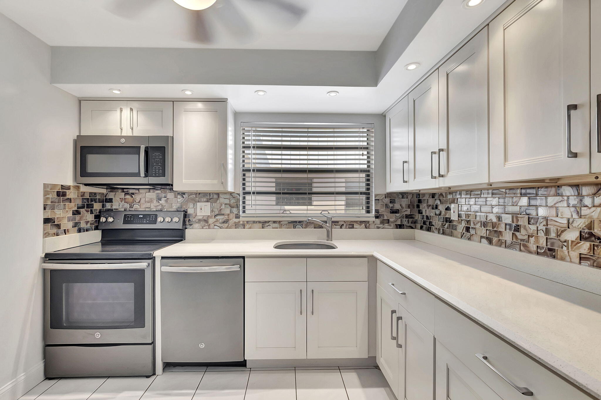 124 Capri B Delray Beach, FL 33484 - Photo 3 of 69 a kitchen with cabinets appliances a sink and a counter top space