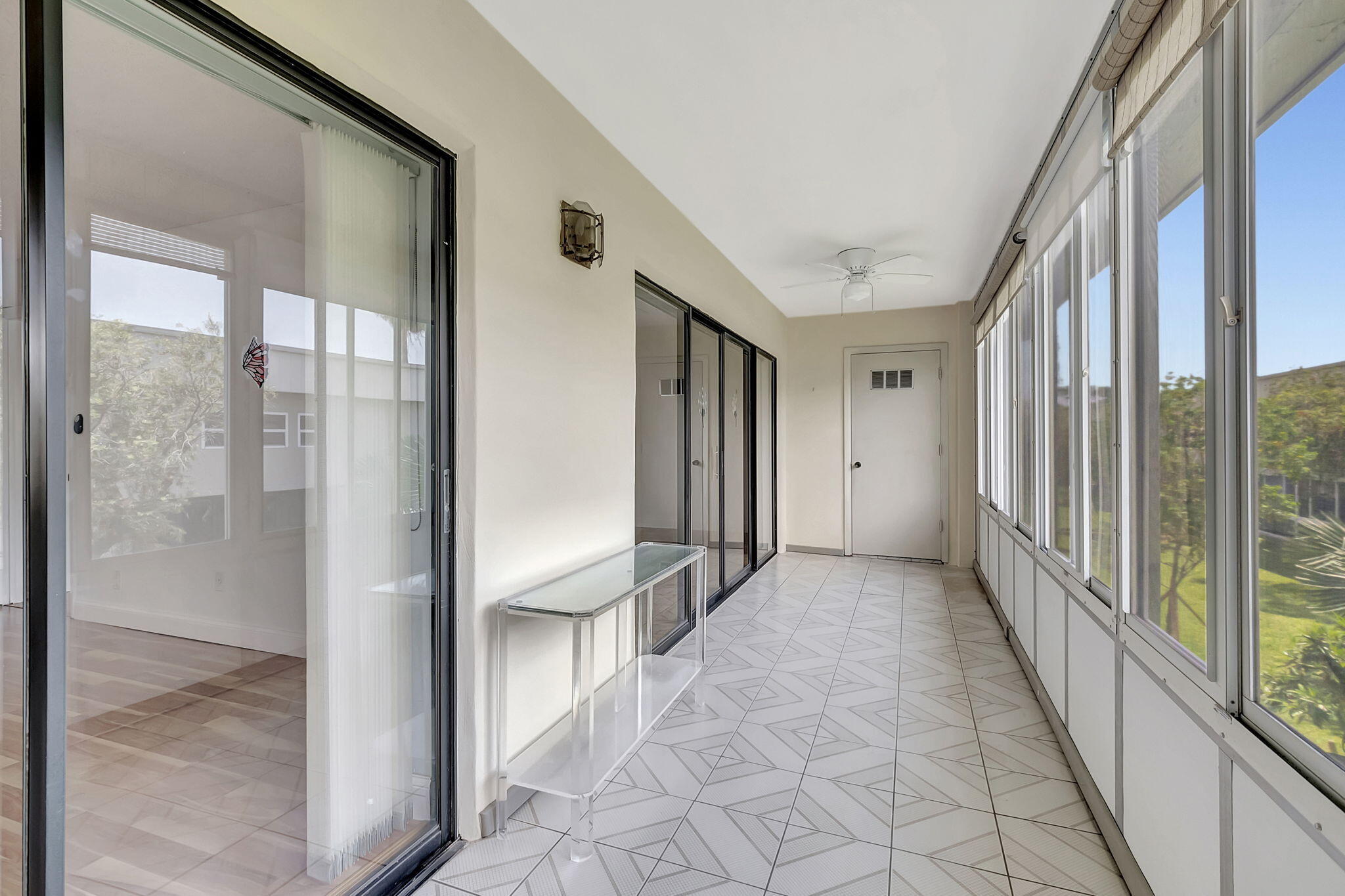 124 Capri B Delray Beach, FL 33484 - Photo 31 of 69 a view of a hallway with wooden floor and entryway