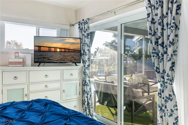 a living room with a bed and a flat screen tv