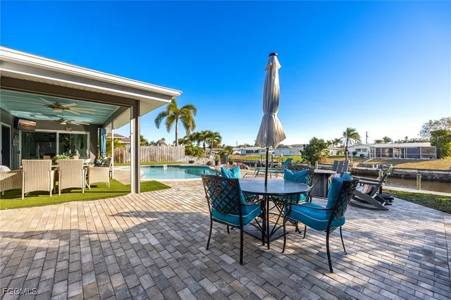 a view of a patio with a table and chairs