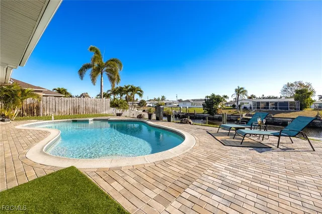 a view of a swimming pool with outdoor seating
