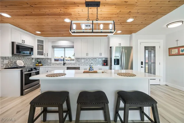 a kitchen with stainless steel appliances granite countertop a sink and cabinets