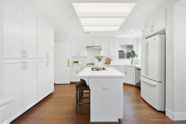 a utility room with cabinets washer and dryer